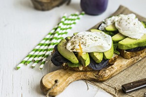 Healthy sandwich with avocado and poached eggs